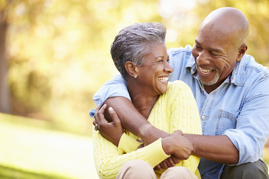 Senior Couple Relaxing In Autumn Landscape